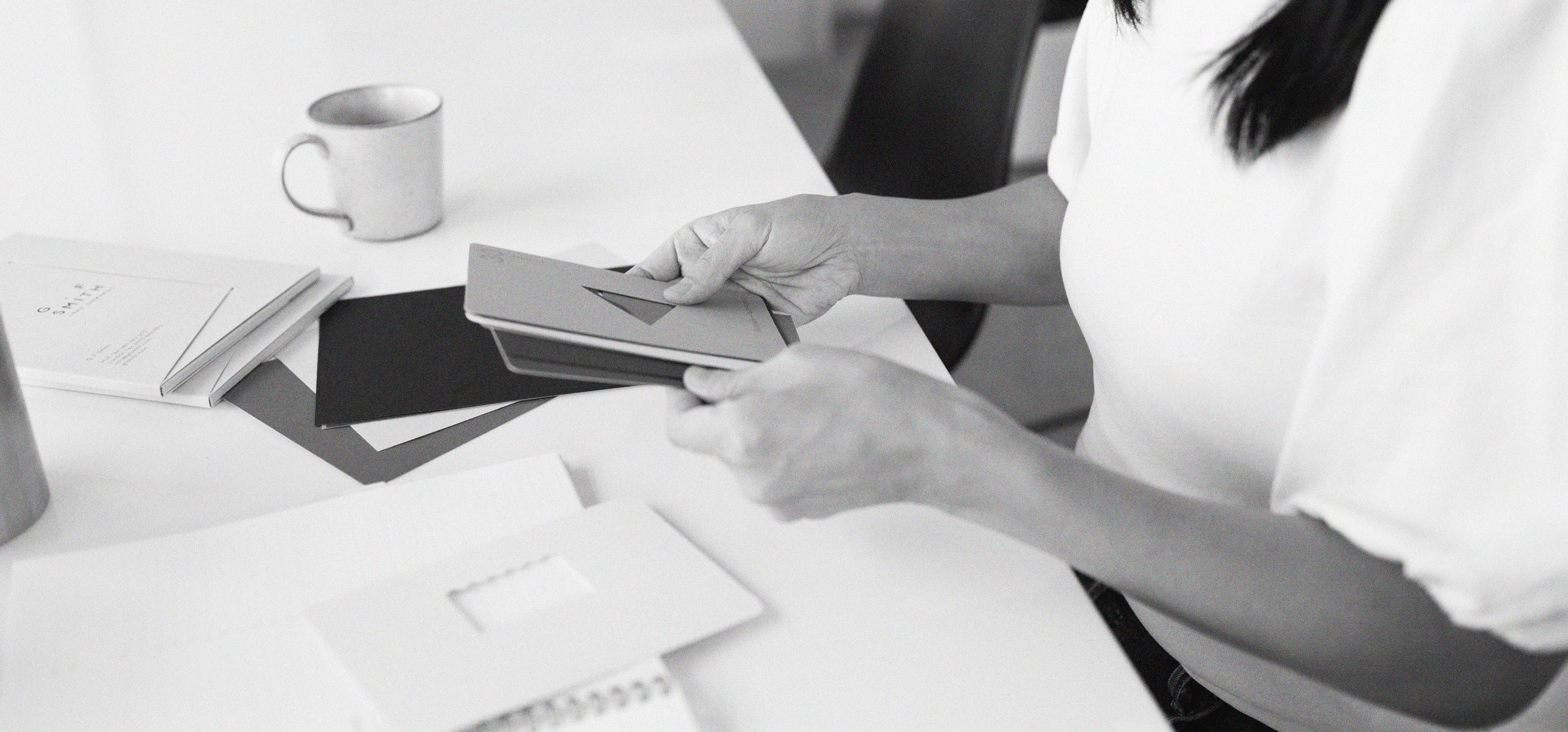 Our founder Suann rifles through bookcloth cover swatches at our Ivy City, D.C. studio