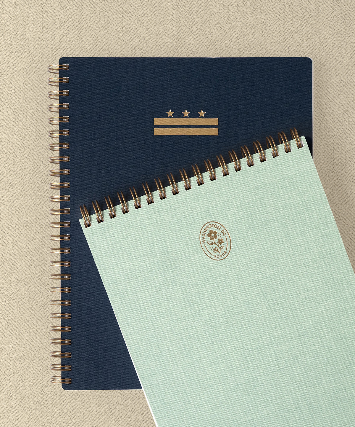 The D.C. Workbook and District Notepad are stacked, offset, against a beige background.