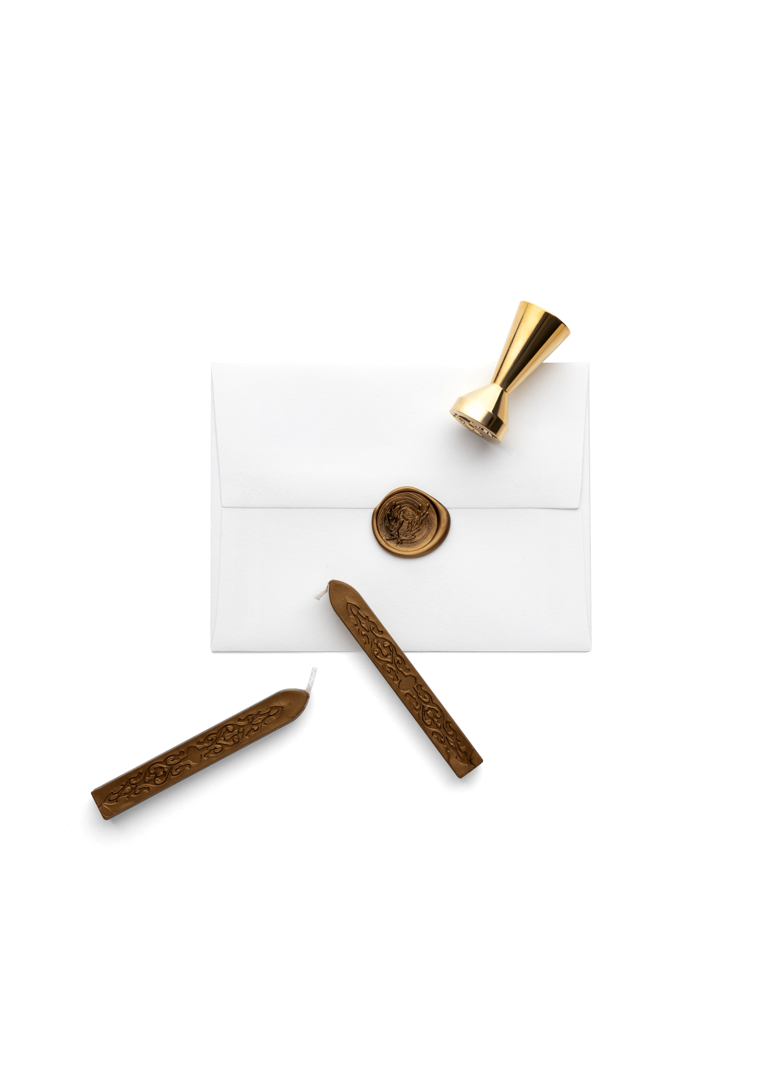 Two wax sticks and the brass seal laying on top of an envelop showing the seal