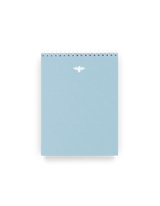 District Notepad supporting World Central Kitchen efforts in Ukraine, front view with white wire-o and white foilstamp dove || Sky Blue