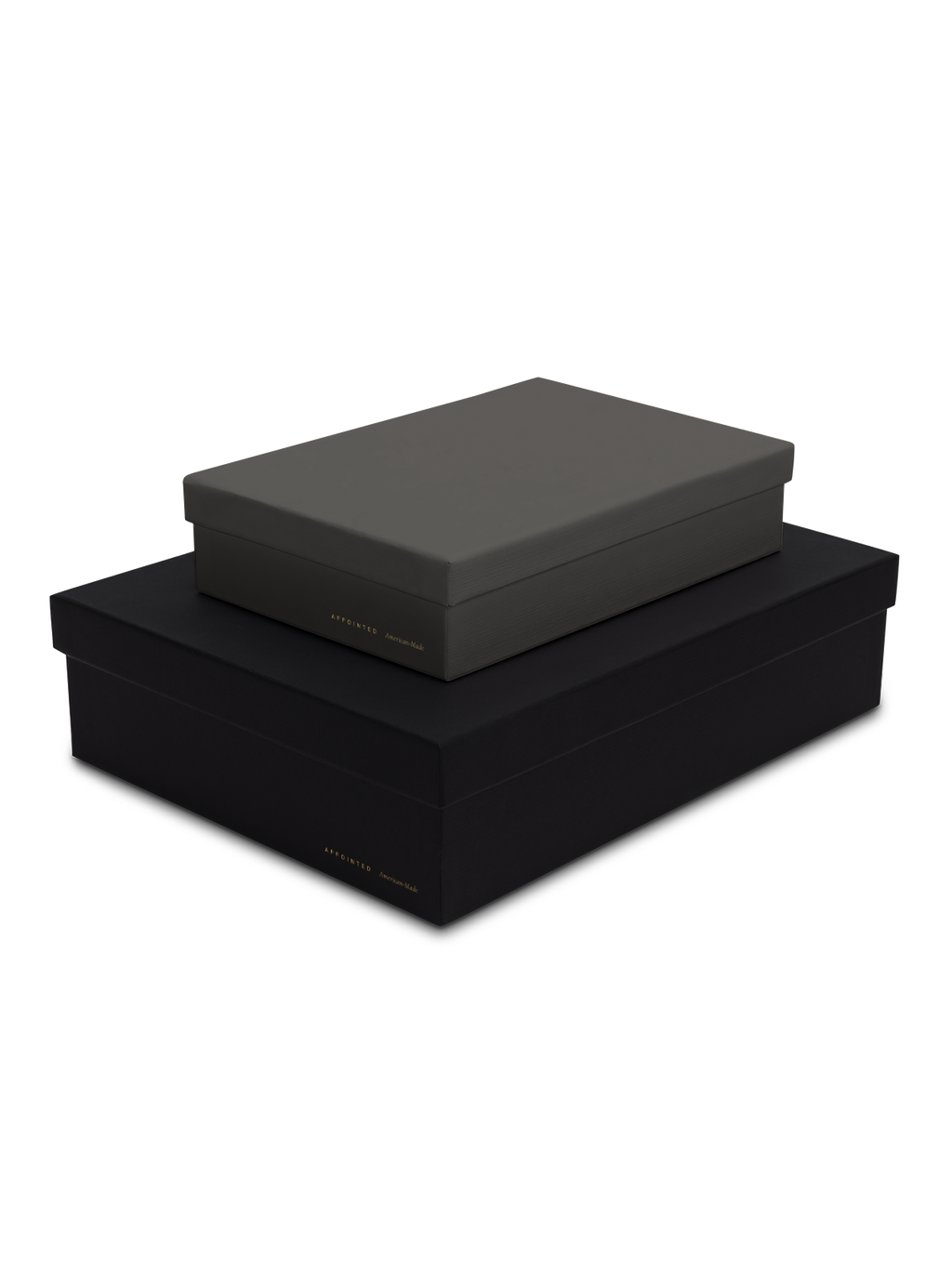 Diagonal view of smaller slate box stacked on top of a bigger charcoal box, both with gold foil details || Onyx and Slate