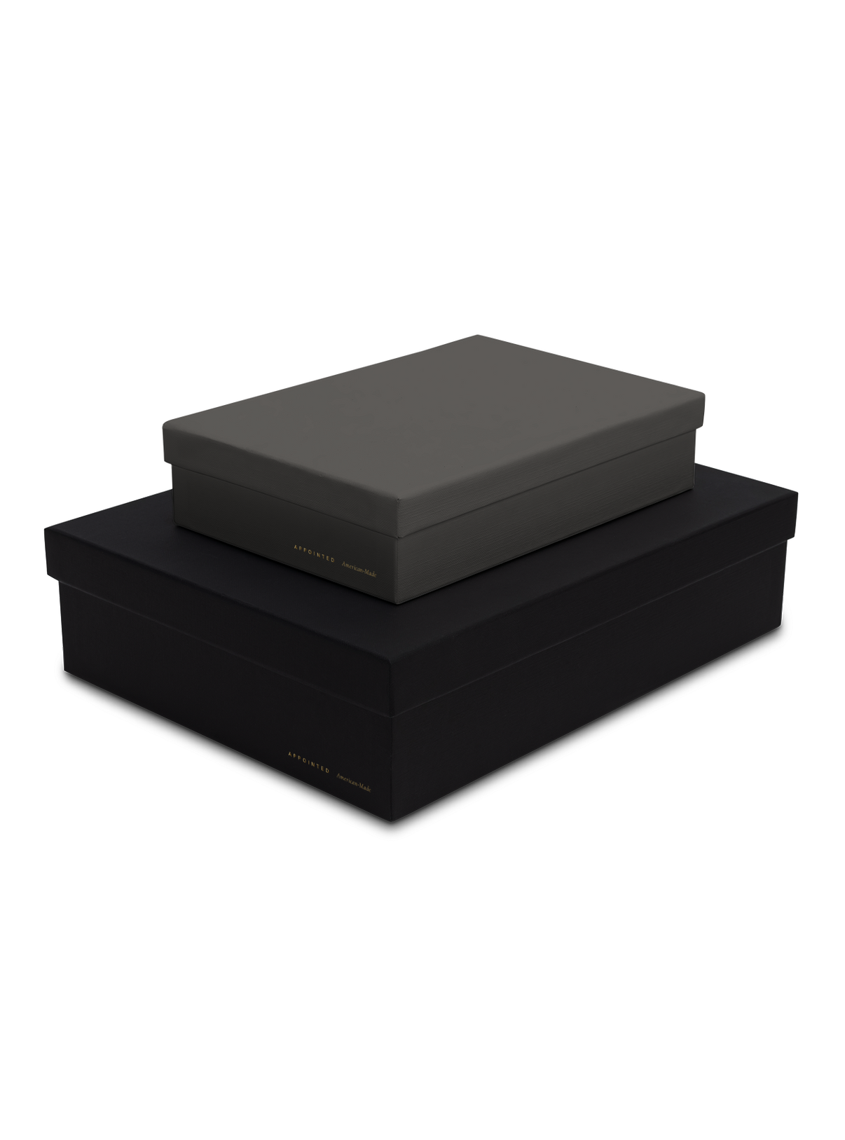 Diagonal view of smaller slate box stacked on top of a bigger charcoal box, both with gold foil details || Onyx and Slate